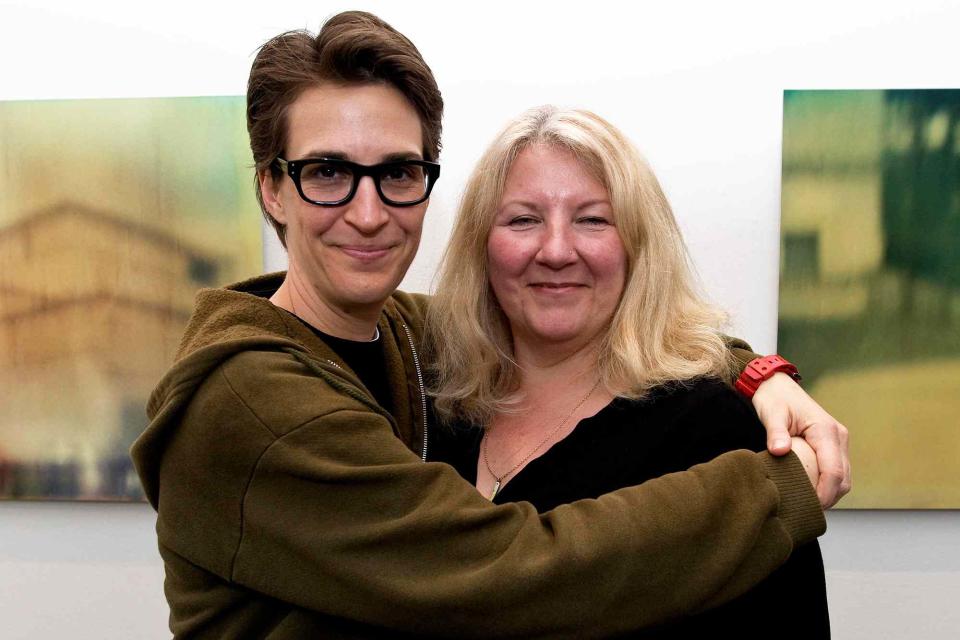 <p>ZUMA Press, Inc. / Alamy</p> Rachel Maddow and Susan Mikula at the opening reception for Mikula