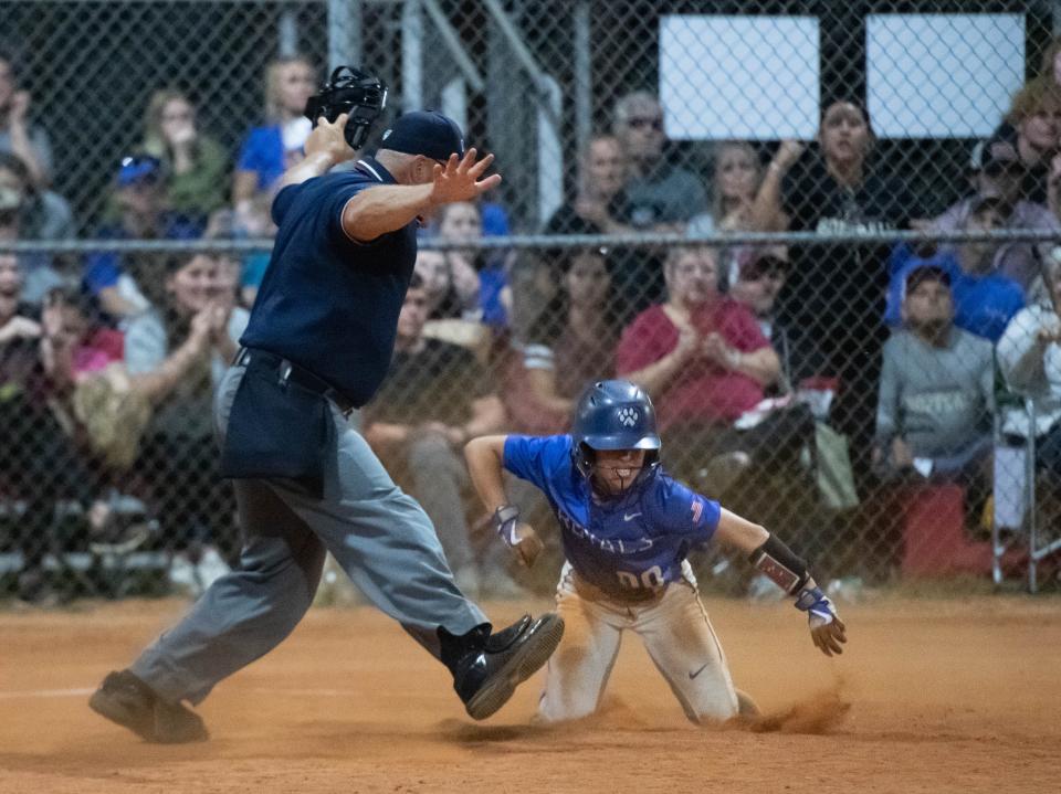 Ella Nelson (00) celebrates scoring from third base as Brett Watson (1) lays down a bunt to tie the game at 6-6 in the top of the 7th inning during the Jay vs Northview District 1-1A championship softball game at Central High School in Milton on Thursday, May 2, 2024.