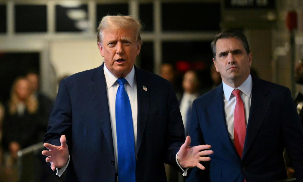 <span>Donald Trump, flanked by his lawyer Todd Blanche, speaks on his way into court on Monday.</span><span>Photograph: Angela Weiss/AP</span>