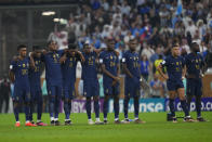 FILE - French players stand dejected during the penalty shootout during the World Cup final soccer match between Argentina and France at the Lusail Stadium in Lusail, Qatar, Sunday, Dec. 18, 2022. In France, where Black players from the men's national team were targeted with horrific racial abuse online after they lost in last year's World Cup final.(AP Photo/Petr David Josek, File)