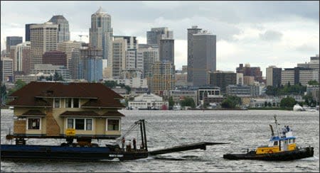 Nicknamed 'the Superbowl of of all house moves,' this arts-and-crafts-style house was lowered off a 20-foot cliff and onto a barge to be moved from downtown Seattle to the San Juan Islands.