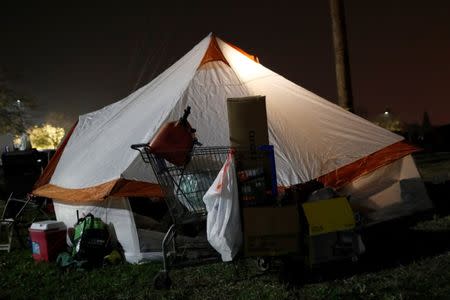 A tent is illuminated at a makeshift evacuation center for people displaced by the Camp Fire in Chico, California, U.S., November 15, 2018. REUTERS/Terray Sylvester
