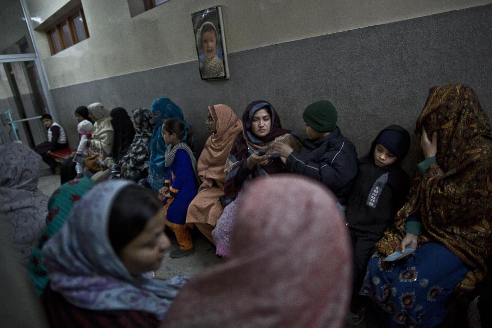 This Feb. 15, 2014, photo shows Pakistani patients, sitting in the waiting area for their turn to be examined, at St. Joseph’s Hospice, in Rawalpindi, Pakistan. Mohammed Aqeel spent weeks at home in Pakistan waiting for death after suffering a debilitating spinal cord injury in a car crash before friends suggested he come to St. Joseph’s Hospice on the outskirts of the capital, Islamabad. Now 13 years later, his life and those of some 40 others who live on its grounds might be changed forever as this hospital of last resort faces closure over its rising debts. (AP Photo/Muhammed Muheisen)