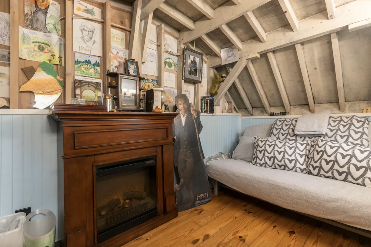 Cozy Hobbit House Interior: fireplace, couch, art on the walls
