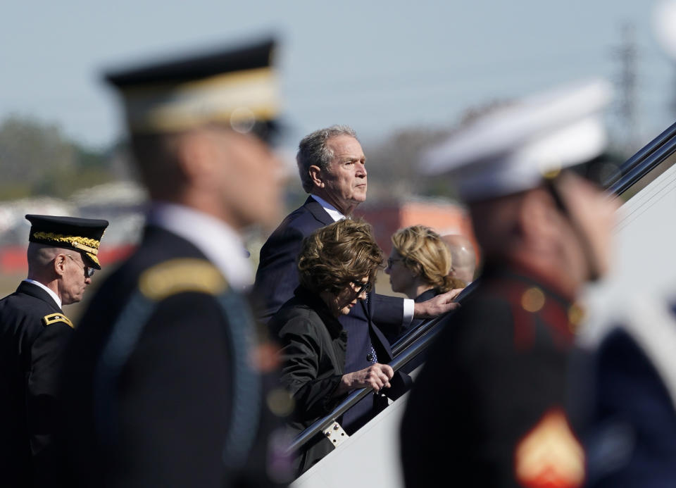 Former President George W. Bush and Laura Bush boards the plane after the casket of his father, former President George H.W. Bush, was placed on the plane during a departure ceremony at Ellington Field Monday, Dec. 3, 2018, in Houston. (Photo: David J. Phillip, Pool/AP)