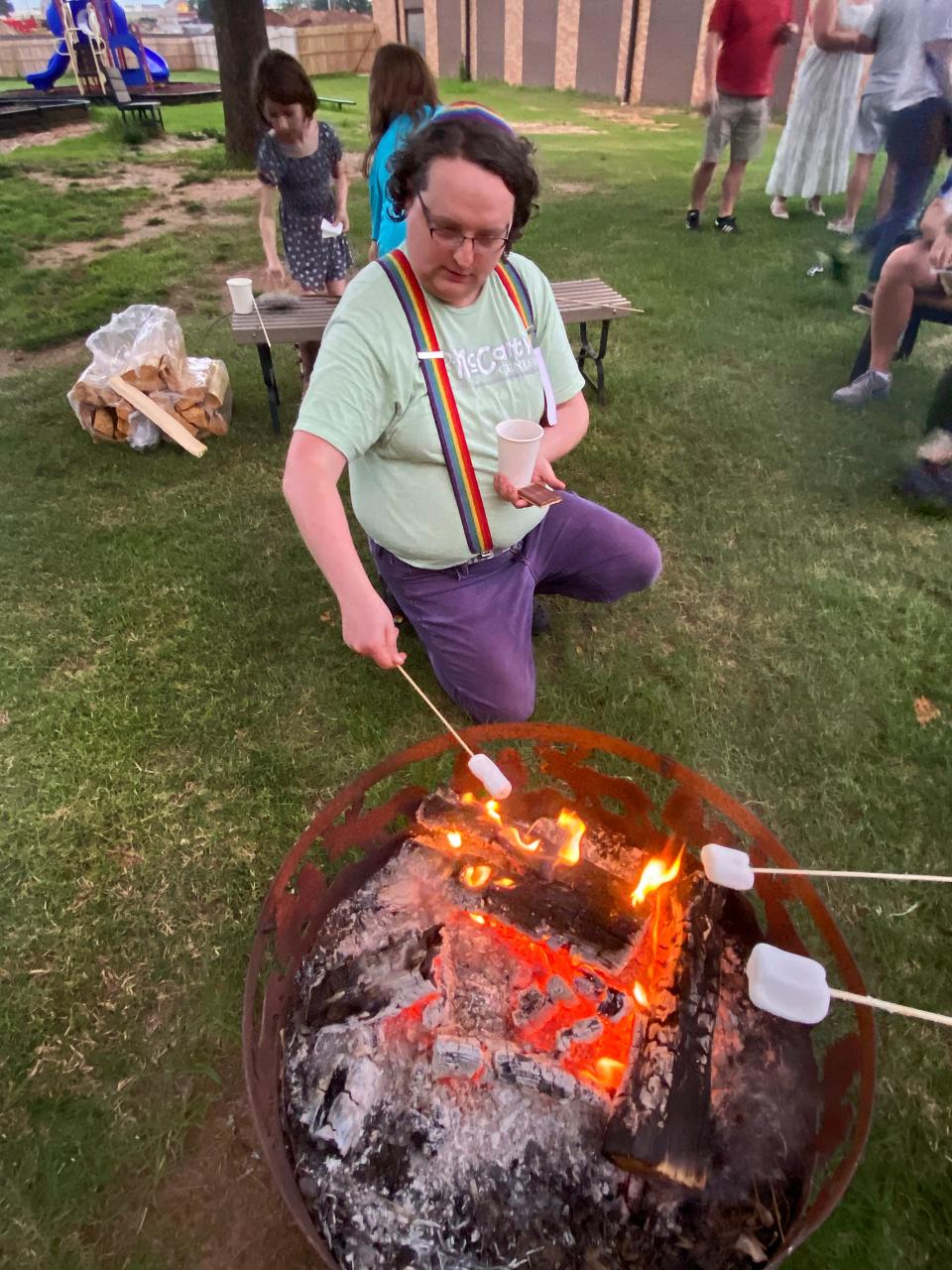 Oswyn Wormley, of Norman, roasts marshmallows for s'mores at the outdoor Shavuot campout at Temple B'nai Israel in Oklahoma City.