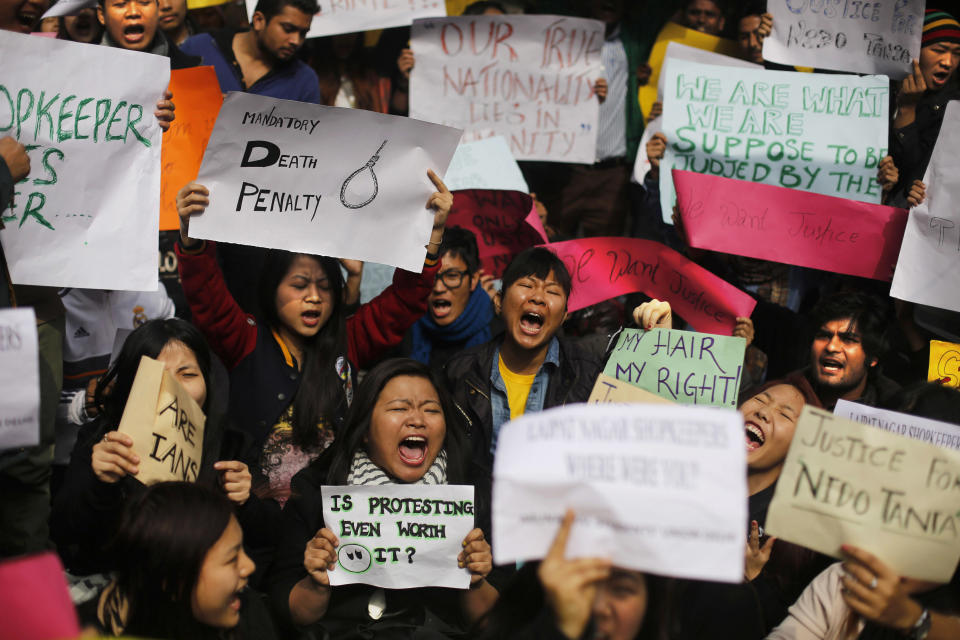 Protesters mostly students from northeastern states of India shout slogans during a protest in New Delhi, India, Saturday, Feb. 1, 2014. The beating and subsequent death in New Delhi of a university student, 20-year-old Nido Tania, from India's remote northeast has sparked a furious outcry against racism and criticism of police in the Indian capital. (AP Photo/Altaf Qadri)