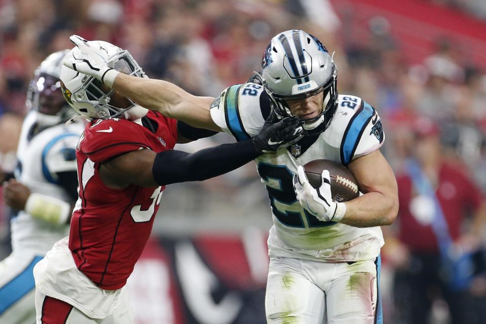 Carolina Panthers running back Christian McCaffrey (22) breaks away from Arizona Cardinals free safety Jalen Thompson, left, during the first half of an NFL football game Sunday, Nov. 14, 2021, in Glendale, Ariz. (AP Photo/Ralph Freso)