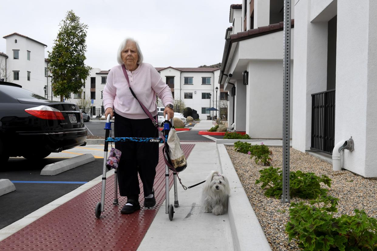 Sandie Moore, 81, walks outside her building in the Vintage at Anacapa Canyon senior apartments in Camarillo April 12. Moore recently moved into the complex after several delays.