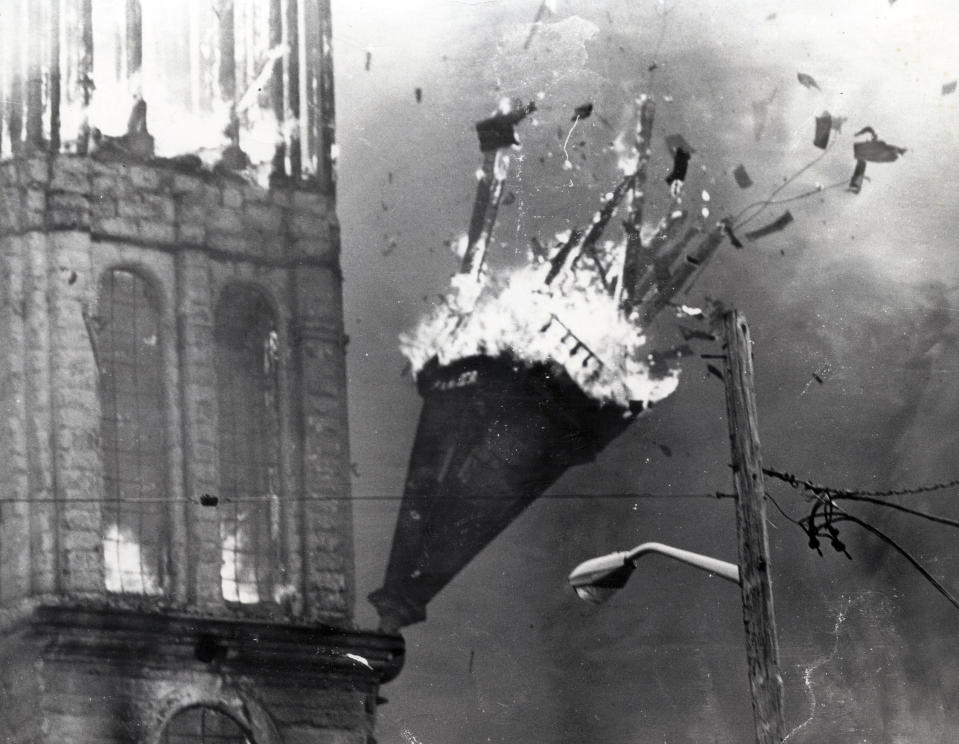 In this May 11,1982 photo, a steeple falls as the Notre Dame de Lourdes Church burns in Fall River, Mass. The cathedral was completed in 1891 and was in the midst of a $1 million renovation when the fire occurred. It was determined that a worker's blowtorch had ignited dry roof timbers. (The Herald News via AP)