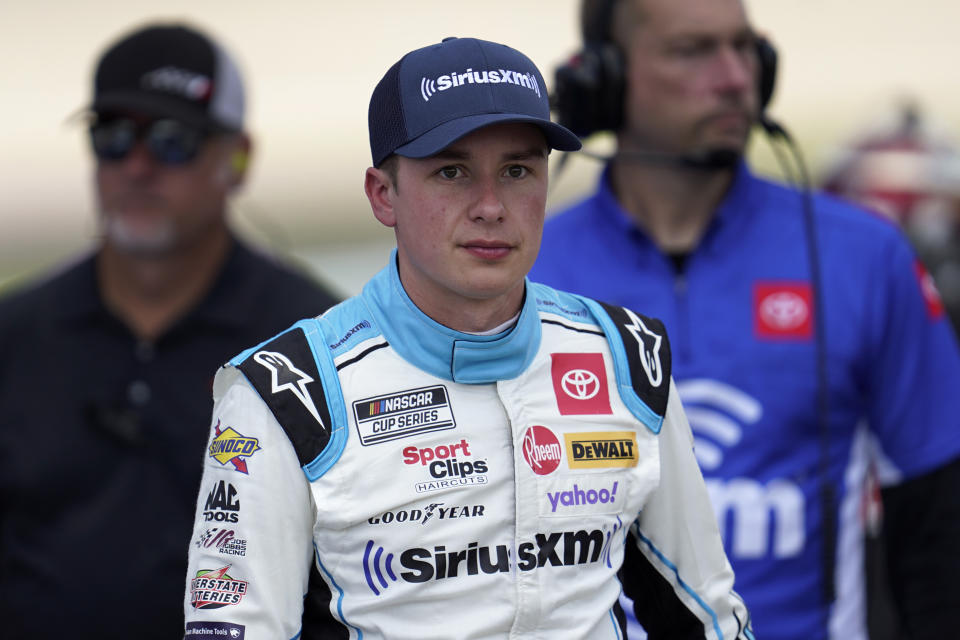 Christopher Bell watches during NASCAR Cup Series auto race qualifying at the Michigan International Speedway in Brooklyn, Mich., Saturday, Aug. 6, 2022. (AP Photo/Paul Sancya)