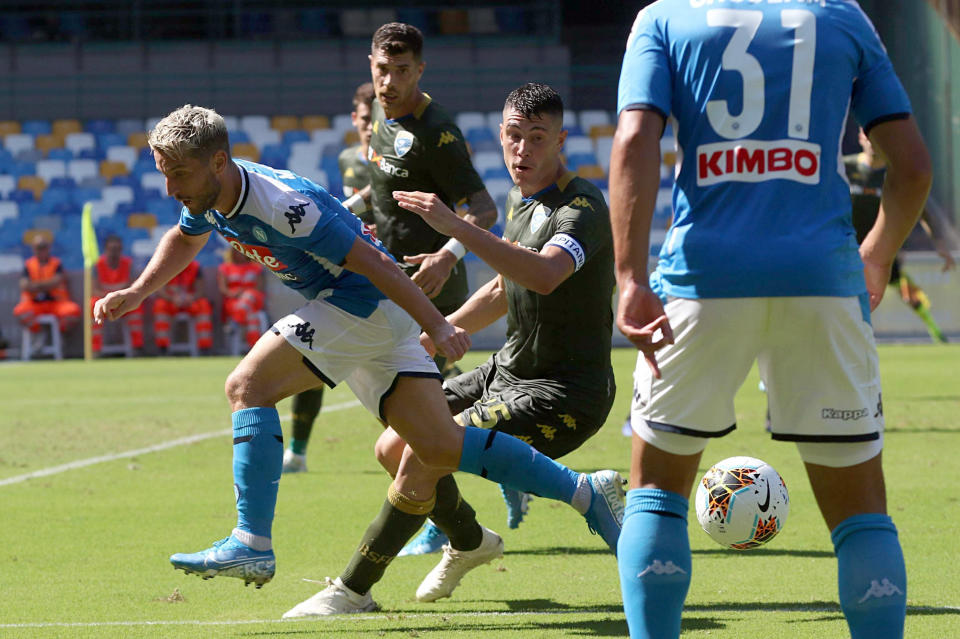 Napoli's Dries Mertens, left, is challenged by Brescia's Daniele Gastaldello during the Serie A soccer match between Napoli and Brescia, at the San Paolo stadium in Naples, Italy, Sunday, Sept. 29, 2019. (Cesare Abbate/ANSA via AP)