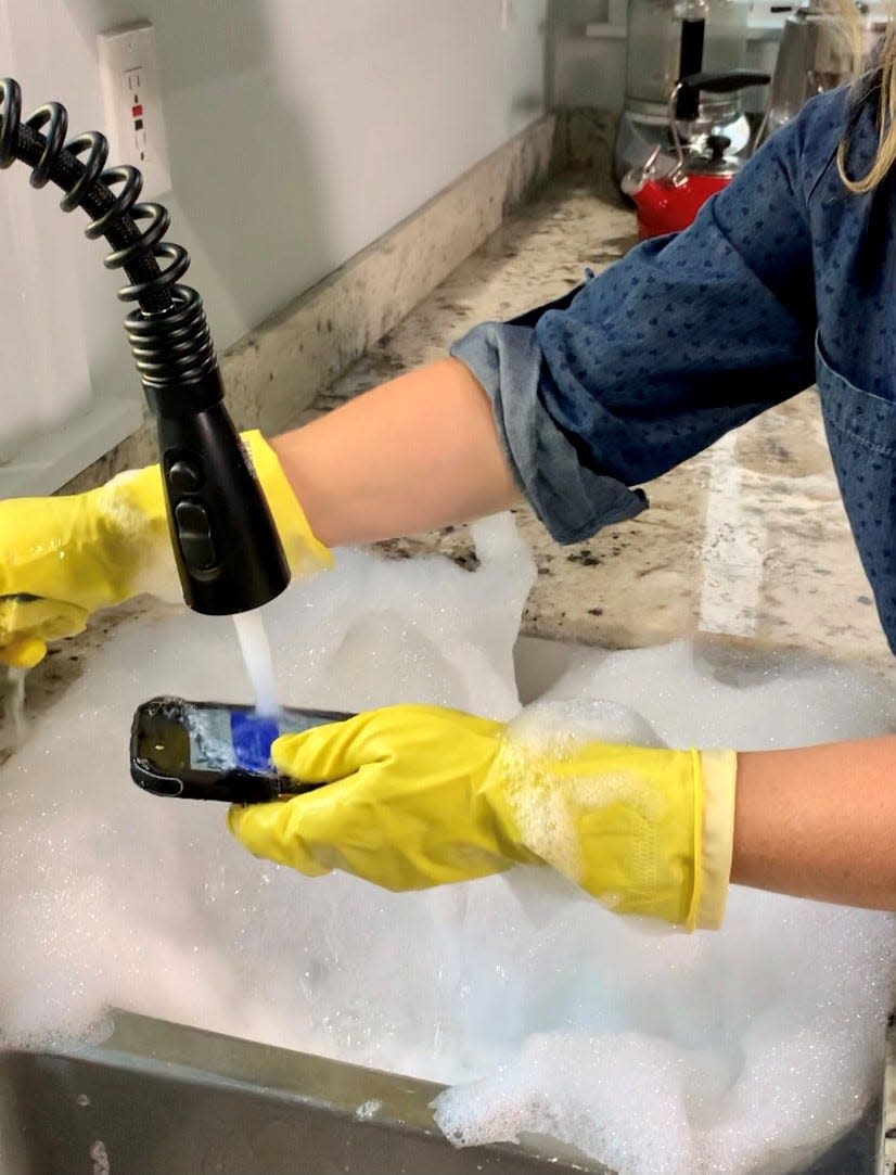 Tech contributor Jennifer Jolly washes a brand new Cat cell phone with soap and water. While this particular smartphone is made to submerge and clean this way, this process would damage or destroy many smartphones.