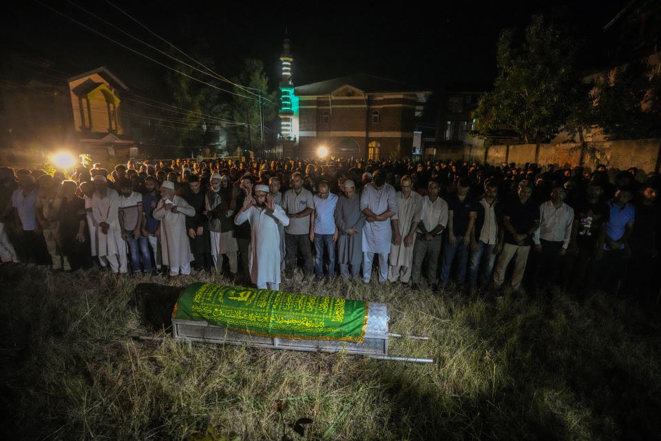 Relatives and colleagues offer prayers in front of the coffin of the Indian police officer Humayun Bhat at his funeral outside his home on the outskirts of Srinagar, Indian controlled Kashmir, Wednesday, Sept 13, 2023. Three Indian soldiers and a police officer were killed in separate gunfights with rebels over the past two days in the mountainous Indian-controlled Kashmir, officials said Wednesday. (AP Photo/Mukhtar Khan)