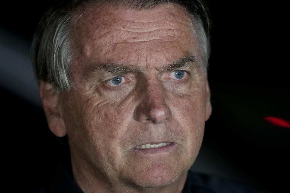 Brazilian President Jair Bolsonaro, who is running for another term, gestures during a press conference after general election polls closed in in Brasilia, Brazil, Sunday, Oct. 2, 2022. (AP Photo/Eraldo Peres)