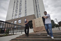 <p>Two men carry a television set from the Dorney Tower residential block, as residents were evacuated as a precautionary measure following concerns over the type of cladding used on the outside of the buildings on the Chalcots Estate in north London, Britain, June 25, 2017. (Photo: Hannah McKay/Reuters) </p>