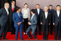 Canada's Prime Minister Justin Trudeau shares a joke about his height with New Zealand's Prime Minister Jacinda Ardern during a family photo at the APEC Summit in Port Moresby, Papua New Guinea November 18, 2018. REUTERS/David Gray TPX IMAGES OF THE DAY