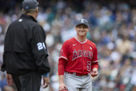 Los Angeles Angels starting pitcher Kenny Rosenberg, right, smiles at the umpire as he leaves during the sixth inning of a win over the Seattle Mariners, Sunday, June 19, 2022, in Seattle. (AP Photo/John Froschauer)
