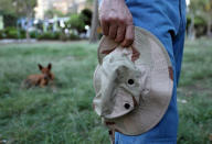 An Iraqi refugee and former interpreter for the U.S. Army in Iraq holds his military hat in a garden on the outskirts of Cairo, Egypt August 8, 2018. REUTERS/Staff