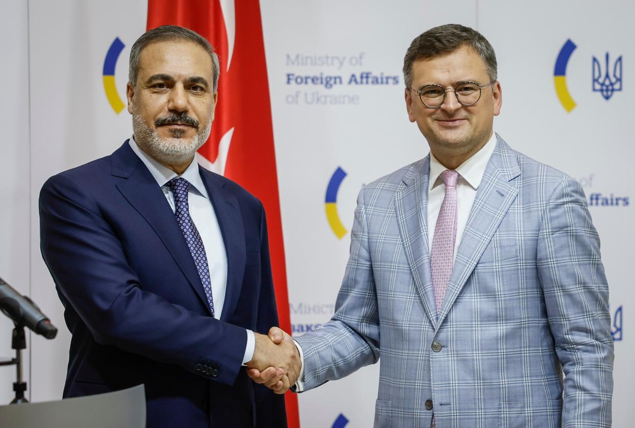 Ukrainian Foreign Minister Dmytro Kuleba, right, and Turkish Foreign Minister Hakan Fidan shake hands as they attend a joint news conference in Kyiv (AP)