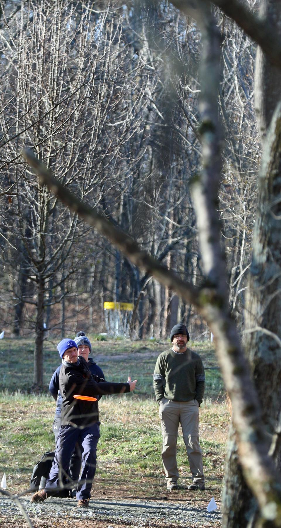 Players compete in the first tournament held at Wolfman Disc Golf Club at Wolfman Woods on Artee Road in Lattimore early Saturday morning, Jan. 29, 2022.