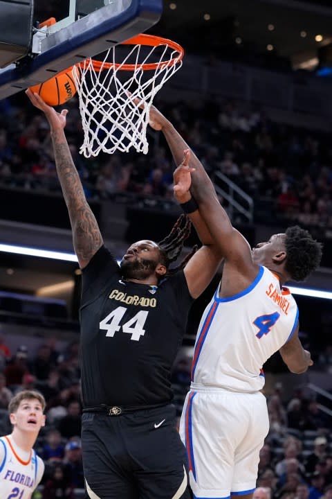 Colorado center Eddie Lampkin Jr. (44) drvies to the basket past Florida forward Tyrese Samuel (4) in the second half of a first-round college basketball game in the NCAA Tournament, Friday, March 22, 2024, in Indianapolis, Ind. (AP Photo/Michael Conroy)