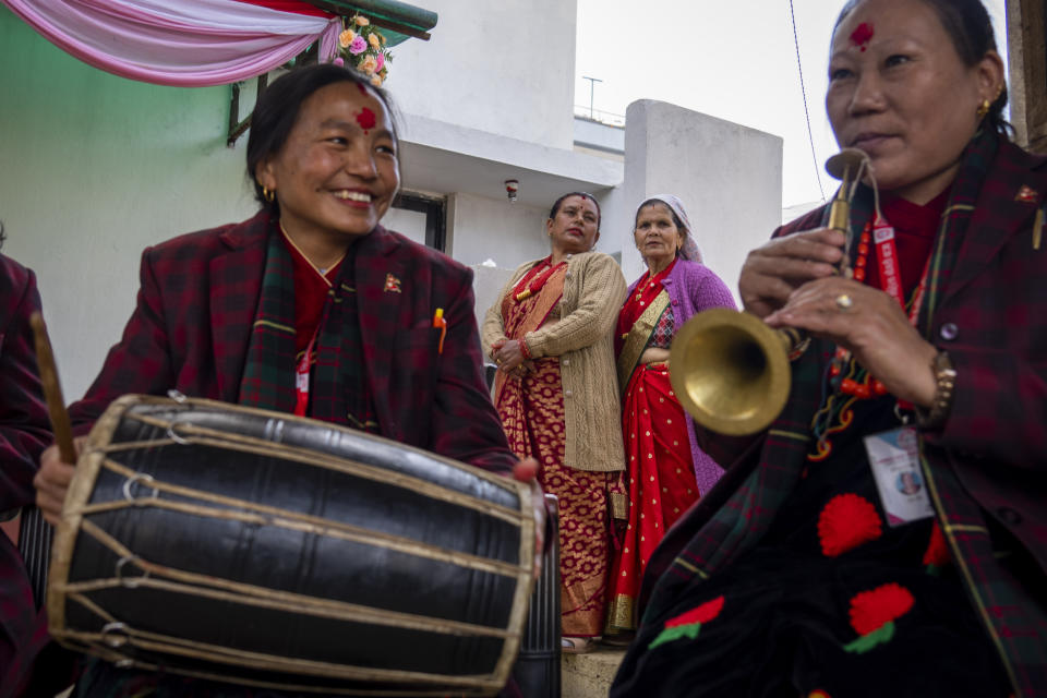 Members of Shrijanshil Mahila Sanstha, or the Self-Reliant Women’s Group, play at a wedding in Kathmandu, Nepal, Wednesday, March 6, 2024. Once associated only with men from the Damai community, part of the lowest caste, nine women from varied castes have come together in this band to play the naumati baja, or nine traditional instruments. (AP Photo/Niranjan Shrestha)