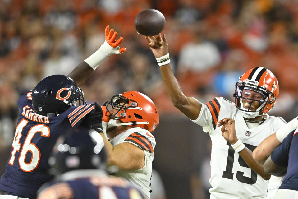 Cleveland Browns quarterback Joshua Dobbs (15) passes as Chicago Bears linebacker Sam Kamara (46) pressures during the first half of an NFL preseason football game, Saturday, Aug. 27, 2022, in Cleveland. (AP Photo/David Richard)