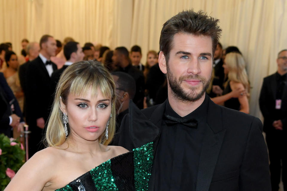 NEW YORK, NEW YORK - MAY 06: Miley Cyrus and Liam Hemsworth attend The 2019 Met Gala Celebrating Camp: Notes On Fashion at The Metropolitan Museum of Art on May 06, 2019 in New York City. (Photo by Karwai Tang/WireImage )