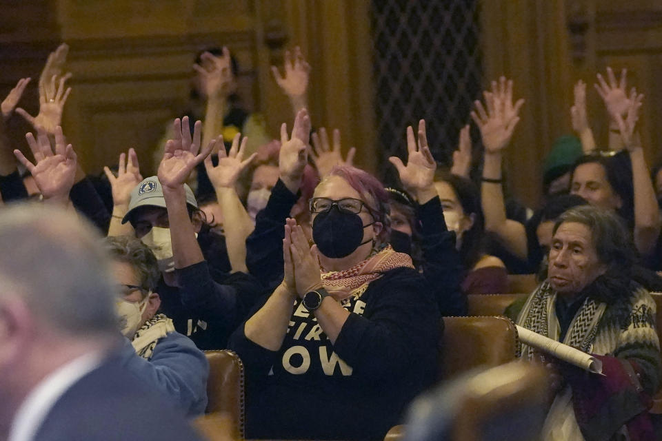 Pro-Palestinian supporters react to speakers during a San Francisco Board of Supervisors meeting in San Francisco, Tuesday, Jan. 9, 2024. San Francisco supervisors approved a slimmed-down resolution calling for a cease-fire in Gaza that condemns Hamas. Three of 11 supervisors voted no, with two saying they could not support a resolution that does not explicitly call out the atrocities of the Oct. 7 attack by Hamas on Israel. (AP Photo/Jeff Chiu)