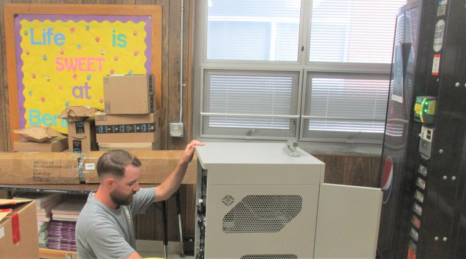 East Holmes technology coordinator Jake Murray works on preparing connections at Berlin Elementary School for the start of the new school year.