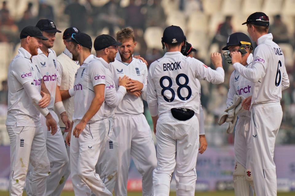 England’s Joe Root, centre, celebrates with team-mates after taking the wicket of Pakistan’s Muhammad Ali, right, during the second day of the second test cricket match between Pakistan and England, in Multan, Pakistan, Saturday, Dec. 10, 2022. (AP Photo/Anjum Naveed) (AP)