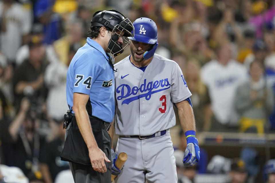 Los Angeles Dodgers' Chris Taylor has a word with home plate umpire John Tumpane after striking out during the sixth inning in Game 4 of a baseball NL Division Series against the San Diego Padres, Saturday, Oct. 15, 2022, in San Diego. (AP Photo/Ashley Landis)