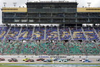 A limited amount of fans watch the start of a NASCAR Cup Series auto race at Kansas Speedway in Kansas City, Kan., Sunday, May 2, 2021. (AP Photo/Colin E. Braley)