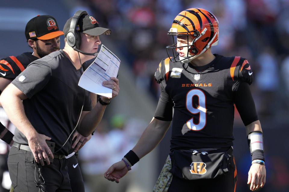 Cincinnati Bengals quarterback Joe Burrow (9) talks with head coach Zac Taylor during the first half of an NFL football game against the Carolina Panthers, Sunday, Nov. 6, 2022, in Cincinnati. (AP Photo/Jeff Dean)