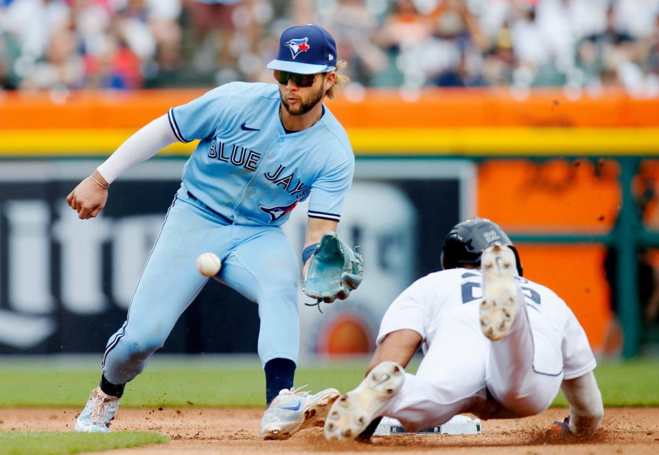 Victor Reyes (22) of the Detroit Tigers beats the pickoff throw to shortstop Bo Bichette (11) of the Toronto Blue Jays to steal second base during the first inning at Comerica Park on June 11, 2022, in Detroit, Michigan.