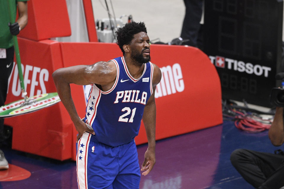 Philadelphia 76ers center Joel Embiid (21) reacts after he fell on the court during the first half of Game 4 in a first-round NBA basketball playoff series against the Washington Wizards, Monday, May 31, 2021, in Washington. (AP Photo/Nick Wass)