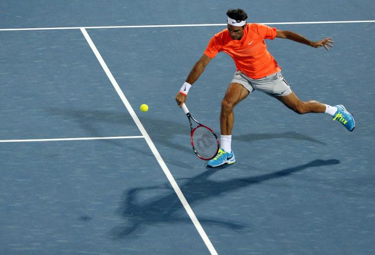 Roger Federer of Switzeland returns the ball to Fernando Verdasco of Spain during their match on the third day of the ATP Dubai Duty Free Tennis Championships February 25, 2015 in Dubai