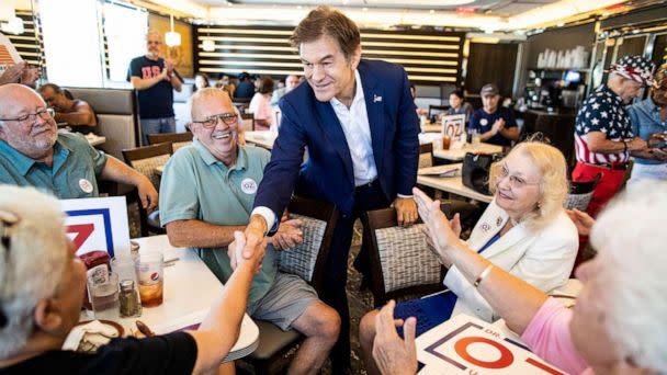 PHOTO: Republican nominee for U.S. Senate, Dr. Mehmet Oz, shakes hands with supporters at The Capitol Diner, on Aug. 12, 2022, in Swatara Township, Pa. (Sean Simmers/The Patriot-News via AP)