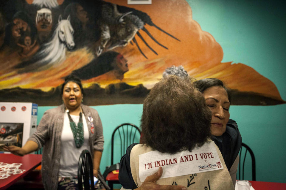 New Mexico congressional candidate Deb Haaland embraces a supporter during her visit to the Albuquerque Indian Center for the Native Vote Celebration in Albuquerque, New Mexico midterms election night Tuesday, Nov. 6, 2018. Haaland and Kansas Democrat Sharice Davids were elected the first two Native American women to serve in Congress. (AP Photo/Juan Labreche)