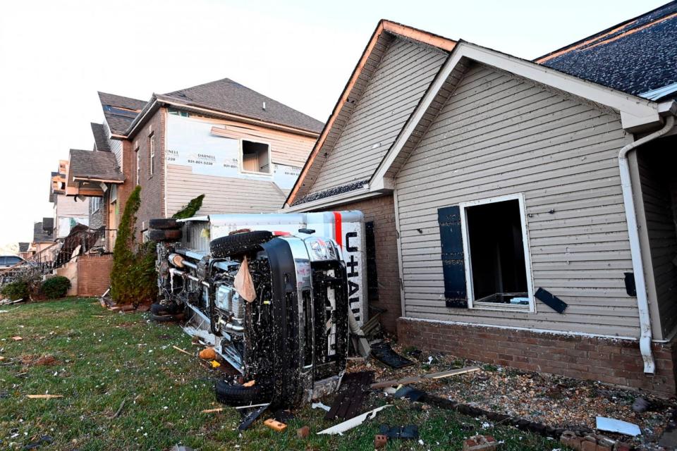 PHOTO: A truck lies on its side beside damaged homes on Dec. 10, 2023, Clarksville, Tenn.  (Mark Zaleski/AP)