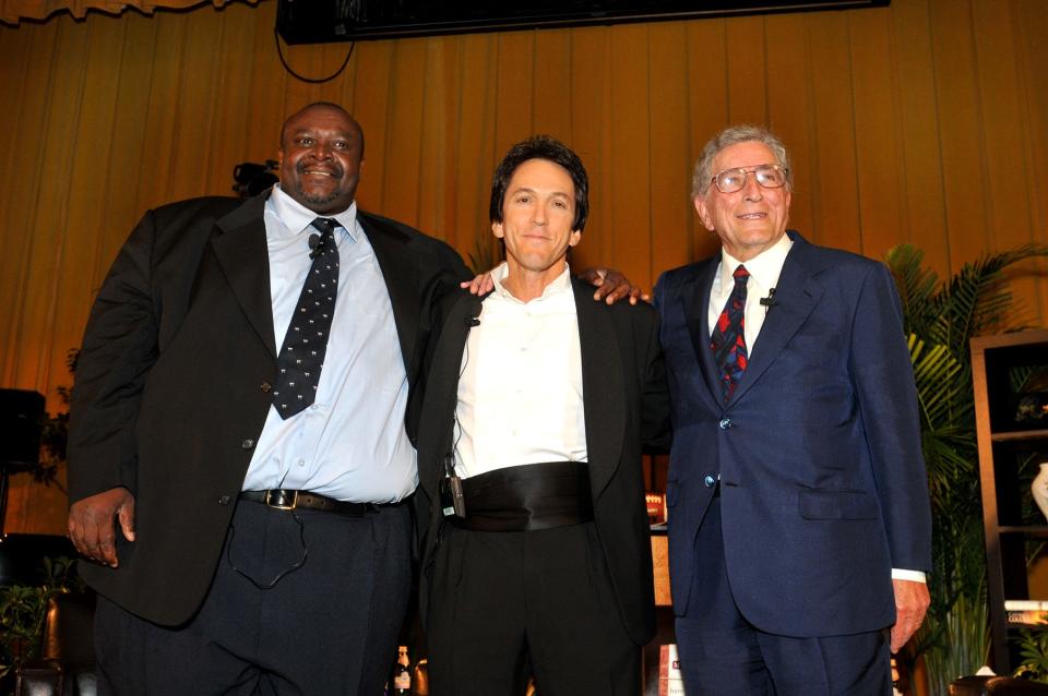Pastor Henry Covington, left, Mitch Albom and Tony Bennett pose during the I Am My Brother's Keeper Church in Detroit.