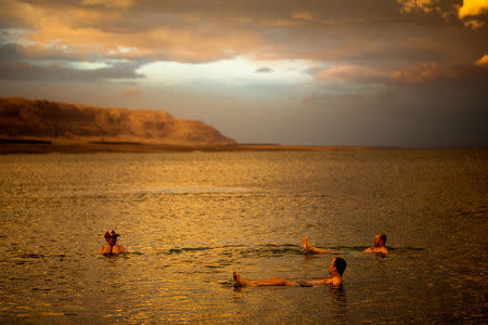 Tourists from Poland float in the Dead Sea during sunset, near Metzoke Dragot in the Israeli occupied West Bank, January 25, 2018. REUTERS/Ronen Zvulun