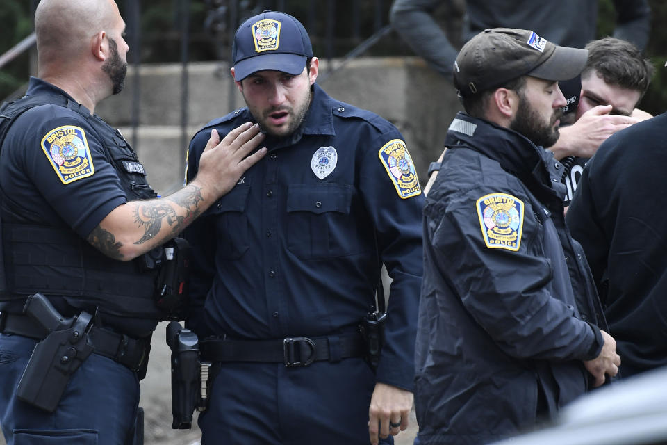 FILE - Bristol, Conn. Police officers console one another at the scene where two police officers killed, Thursday, Oct. 13, 2022, in Bristol, Conn. The deaths of two Connecticut police officers and the wounding of a third during an especially violent week for police across the U.S. fit into a grim pattern, law enforcement experts say. Even as the number of officers has dropped in the past two years, the number being targeted and killed has risen. (AP Photo/Jessica Hill, File)