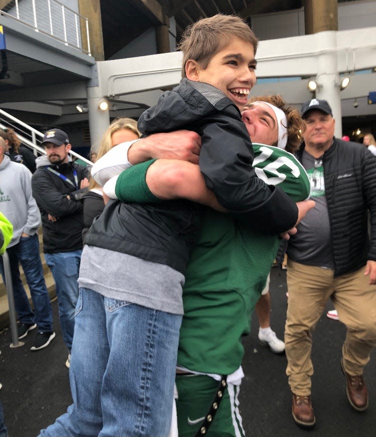 Archmere quarterback Chris Albero greets his cousin following an Auks game. Albero will play his final high school game for the Blue team in the 67th DFRC Blue-Gold game on Friday night at Delaware Stadium.