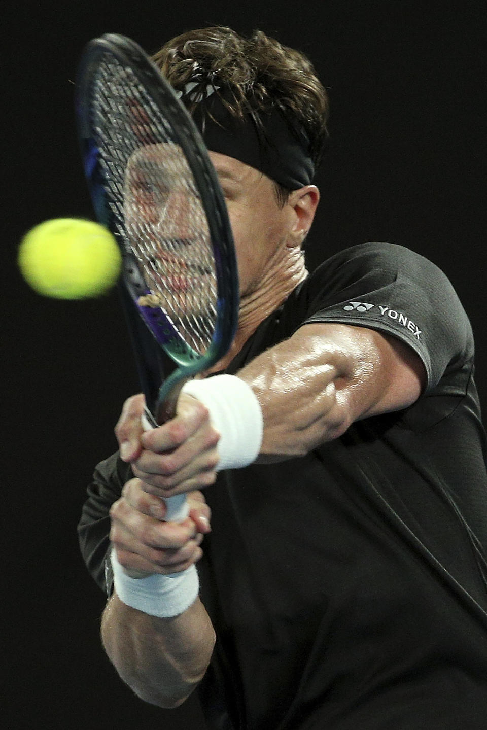 Ricardas Berankis of Lithuania plays a backhand during his singles match against Rafael Nadal of Spain at Summer Set tennis tournament ahead of the Australian Open in Melbourne, Australia, Thursday, Jan. 6, 2022. (AP Photo/Hamish Blair)