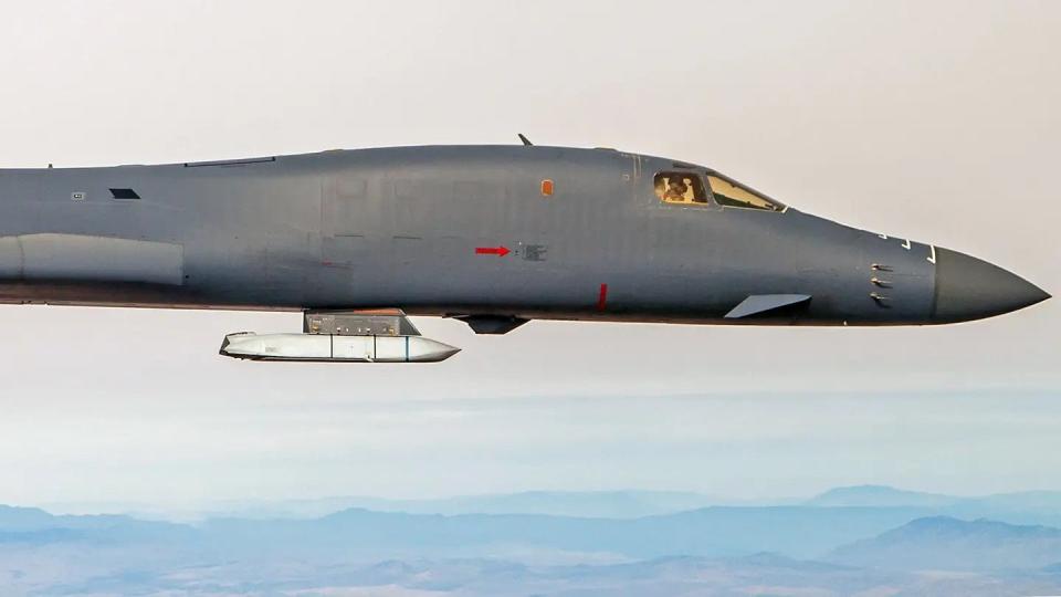 A B-1B bomber carrying an inert AGM-158 Joint Air-to-Surface Standoff Missile (JASSM) on a standard, non-LAM external pylon during a test. <em>USAF</em>