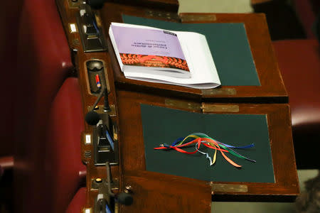 Colored ribbons are seen on a desk before the final vote on gay and unmarried civil unions at the Italy's lower house of Parliament in Rome, Italy May 11, 2016. REUTERS/Alessandro Bianchi