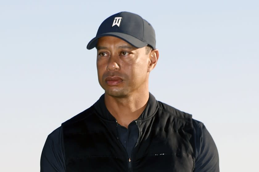 FILE - Tiger Woods looks on during the trophy ceremony on the practice green after the final round of the Genesis Invitational golf tournament at Riviera Country Club, Sunday, Feb. 21, 2021, in the Pacific Palisades area of Los Angeles. Woods was injured Tuesday, Feb. 23, 2021, in a vehicle rollover in Los Angeles County and had to be extricated from the vehicle with the "jaws of life" tools, the Los Angeles County Sheriff's Department said.(AP Photo/Ryan Kang)