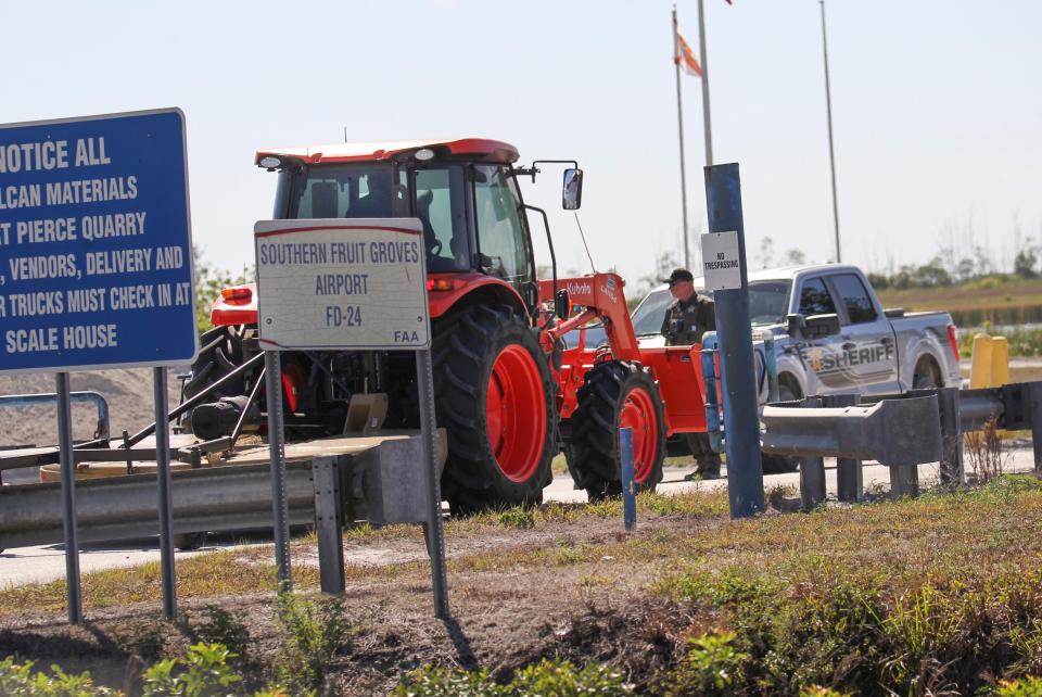 The St. Lucie County Sheriff's Office stands watch at the front gates of the Vulcan Materials quarry along Range Line Road while investigating a possible fatal industrial accident on Thursday, March 16, 2023, in Port St. Lucie. Two small 4x4 vehicles and a tractor arrive on scene during the investigative process.